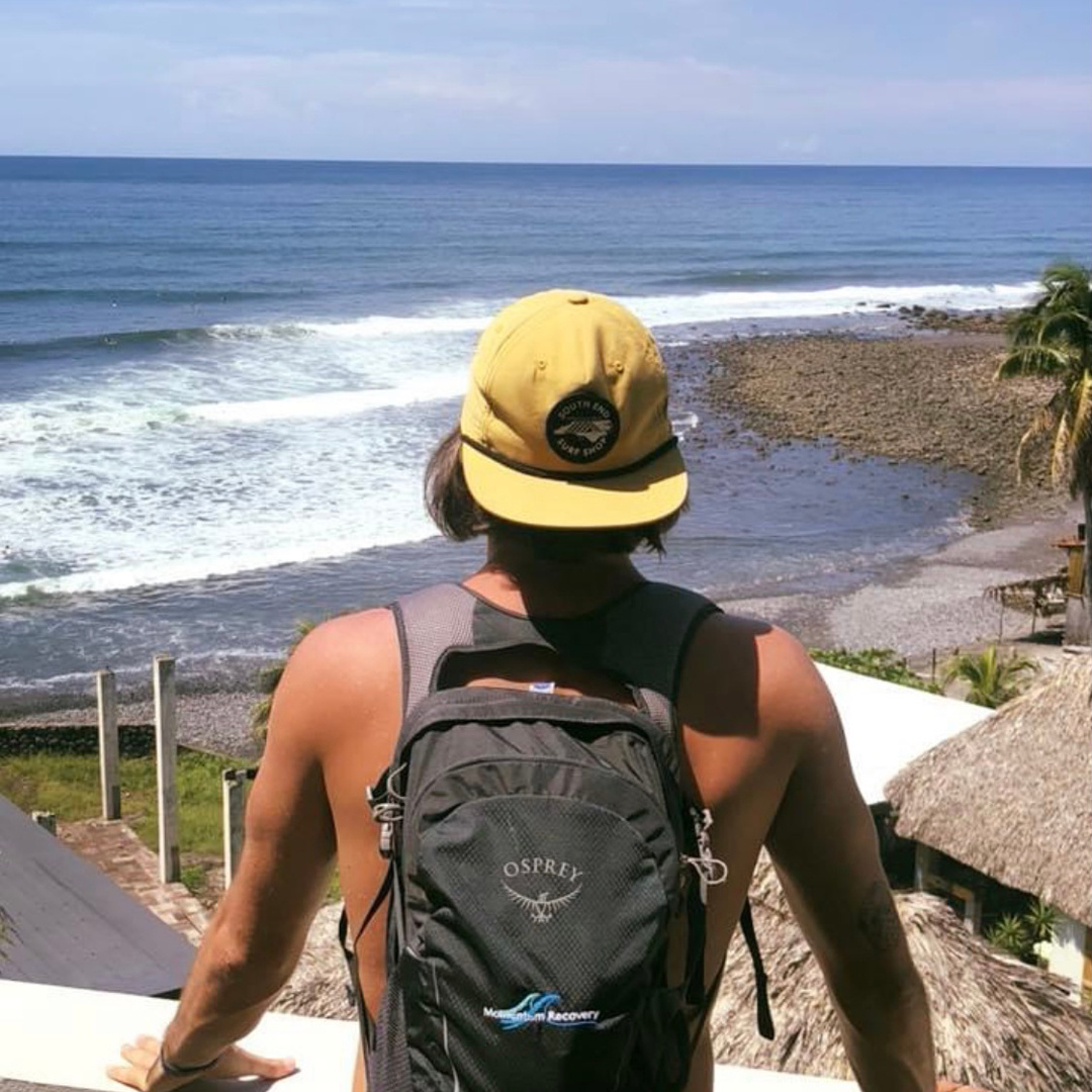 young man on a balcony looking out over the ocean