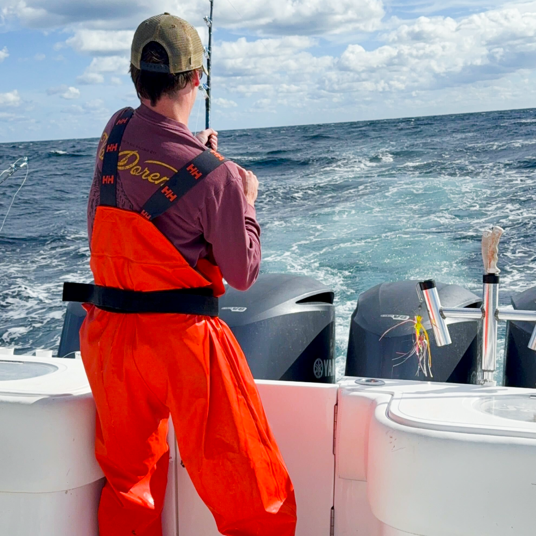 young man deep sea fishing off a boat