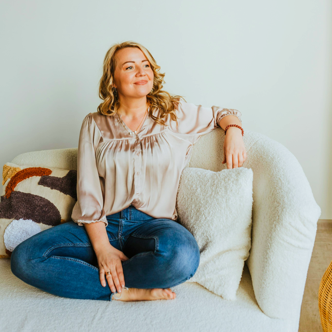 woman sitting cross-legged on a couch